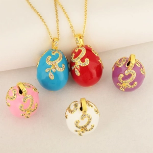 Faberge style colorful enamel egg pendants with golden filigree and sparkling crystals