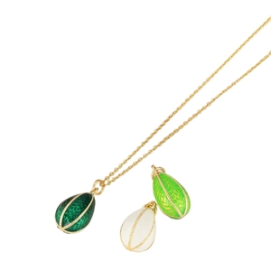 Golden necklace with three egg-shaped enamel pendants in green and white colors