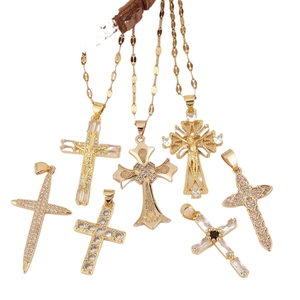 Collection of seven gold-plated cross pendants featuring hollow designs and zircon inlays