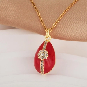 Vintage gold-plated egg pendant necklace with red enamel and sparkling zircon inlay