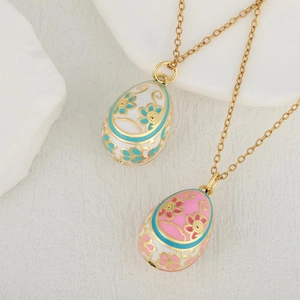 Faberge style enamel egg pendants with floral patterns on gold plated chain necklaces