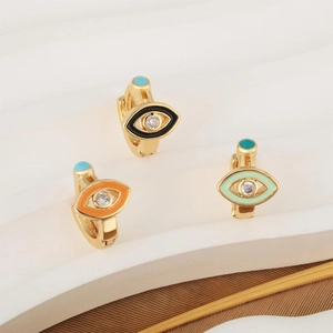 Golden Evil Eye hoop earrings with colorful enamel and turquoise beads on a white stand