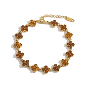 Goldenes Kleeblatt Armband aus Edelstahl mit bernsteinfarbenen Kristallen besetzt