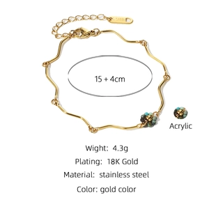 Detail of 18K gold plated stainless steel wave chain bracelet with turquoise acrylic beads