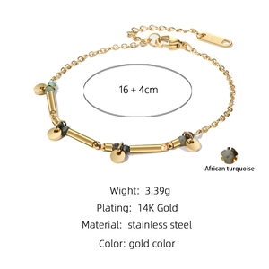 Detail of 14K gold plated stainless steel bracelet with African turquoise and round charms