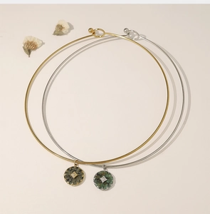 Detail of vintage gold and silver collars with green natural stone star pendants