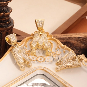 Detail of hip-hop R M Y letter pendants with micro-pave zircons and melting drip effect