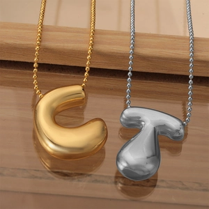 Polished puffy capital letter pendants in gold and silver on delicate ball chains