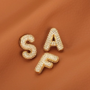 18k gold plated bubble letter pendants S A F with micro-paved zircons on brown leather