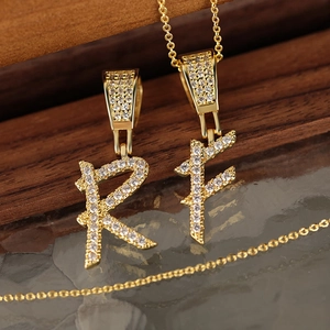 Gold-plated necklaces with R and F initial pendants featuring pavé set cubic zirconia