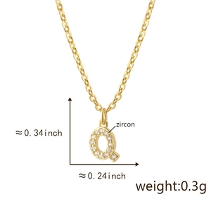 Macro shot of 18K gold letter Q pendant with cubic zirconia and exact dimensions