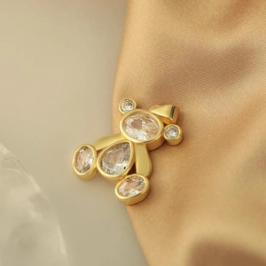 Charming gold teddy bear pendant with micro-pave cubic zirconia on silk fabric