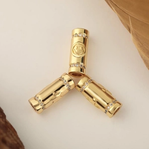 Three gold-plated copper barrel charms with micro-inset zircons and star smiley patterns