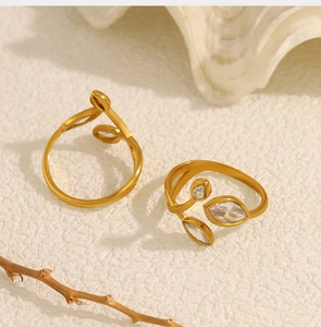 Detailed close-up of 18K gold plated leaf rings featuring marquise-cut zircon stones