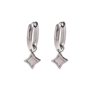 Detailed close-up of silver hoop earrings featuring white shell inlaid star pendants