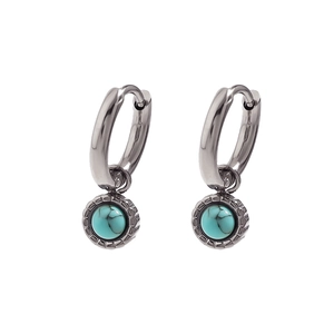 Detail of vintage turquoise hoop earrings featuring polished metal and textured pendants