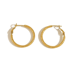 Detail of large gold hoop earrings featuring textured bamboo joint design and clasp