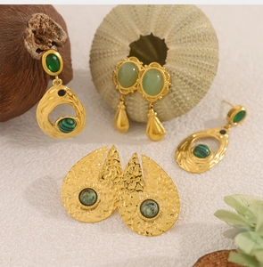 Detailed view of bohemian 18K gold plated earrings with green malachite stone inlay