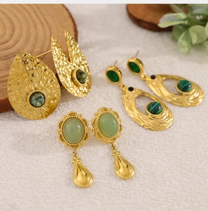 Detailed view of 18K gold-plated vintage earrings set with green natural stone pendants