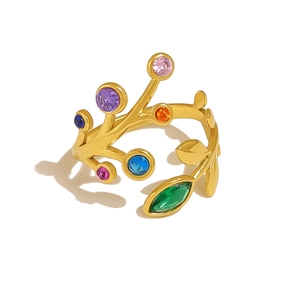 Anello a ramo dorato con zirconi colorati e gemma marquise verde su sfondo bianco puro