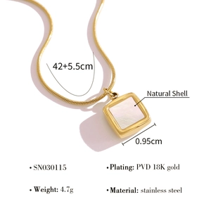 Macro shot of 18K gold plated snake chain with square white shell heart pendant detail