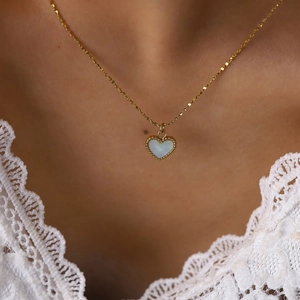 Elegant gold heart pendant necklace featuring white mother of pearl with beaded edge