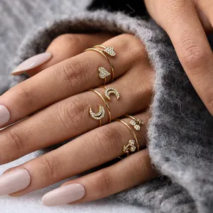 Close-up of 18K gold plated heart and star rings with diamonds on a hand