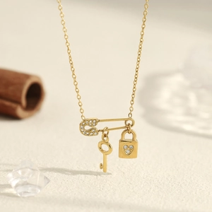 18K gold plated necklace with safety pin pendant featuring a lock, key, and zircon accents