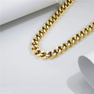 Close-up of polished gold Cuban link chain necklace with high-shine metallic finish