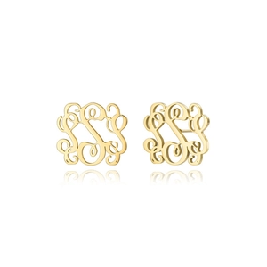 Detailaufnahme goldener Ohrstecker mit filigranen Buchstaben und glänzender Spiegelung
