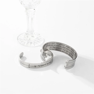 Macro detail of engraved quote Mothers and Daughters never truly part on 10mm cuff bracelet