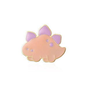 Close-up of a cute orange and purple enamel dinosaur brooch with gold metallic edges