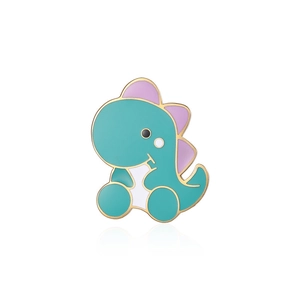 Detailed macro view of a cute mint green cartoon dinosaur enamel pin with purple fins