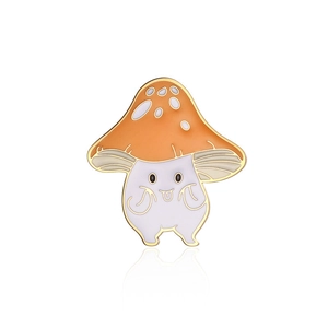 Close-up of cartoon mushroom enamel pin with orange cap and cute purple stem character