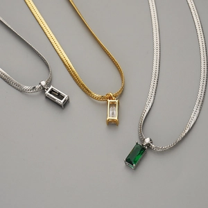 Flat snake bone necklaces with emerald and black zircon rectangular pendants in gold and silver
