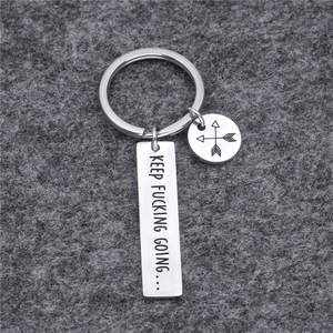 Polished titanium steel keychain with KEEP FUCKING GOING engraving and arrow charm