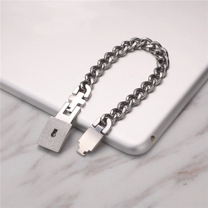Polished titanium steel chain bracelet featuring creative lock and key clasp on marble