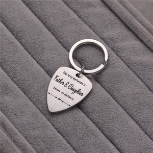 Guitar pick keychain with engraved Father and Daughter quote on steel surface