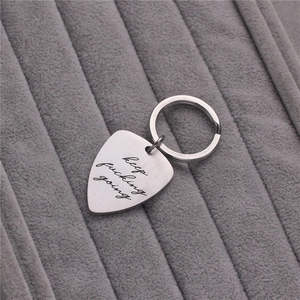 Brushed stainless steel guitar pick keychain with Keep Fucking Going engraving