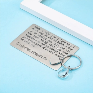 Laser engraved stainless steel heart keychain and romantic card set on light blue background
