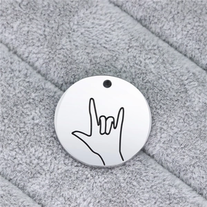 Close-up of a stainless steel round pendant with an engraved I Love You sign language hand