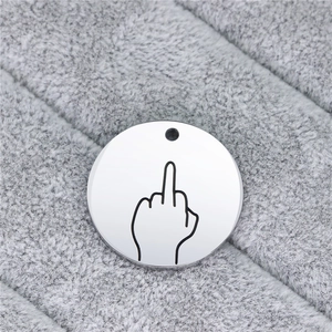 Macro shot of silver stainless steel round tag featuring a minimalist hand gesture engraving