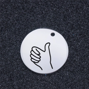 Polished stainless steel round pendant with black etched thumbs up sign on black background