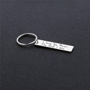 Engraved stainless steel keychain with I Love You Most message on dark textured background