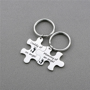 Matching stainless steel puzzle keychains engraved with Daddy and Mommy of an angel
