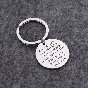 Titanium steel keychain with engraved father tribute on a grey felt background
