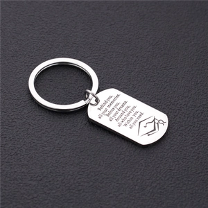 Macro shot of silver stainless steel graduation tag with engraved inspirational quote