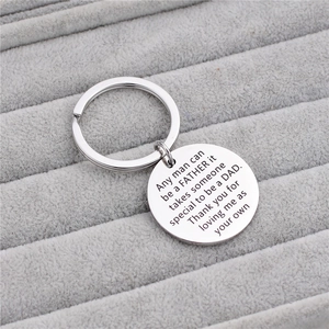 Silver stainless steel Father's Day keychain with engraved emotional message on gift tray