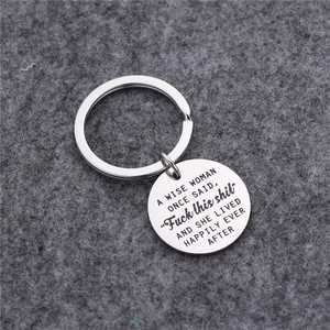 Engraved stainless steel keychain with A Wise Woman Once Said quote on grey felt