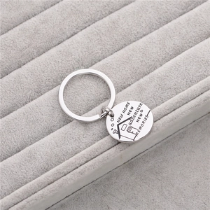 Polished stainless steel keychain with New Home New Adventure engraving on velvet